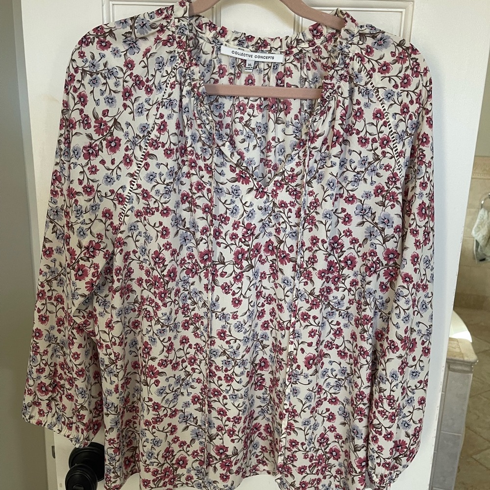 Floral 100% polyester blouse with tie top and elastic sleeves.
